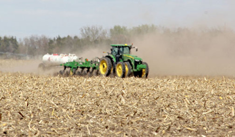 Dust and heat waves blur the view of this tractor as it works in a field in northern Hamilton County on April 20. Planting operations were often accompanied by large clouds of dust as seeds were sown in the dry soil before the recent rains.