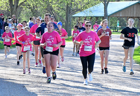 Approximately 30 girls from Aurora and Hampton and their run buddies ran a 5K through Streeter Park Monday evening, the last leg of an international nonprofit program designed to help build self-esteem.