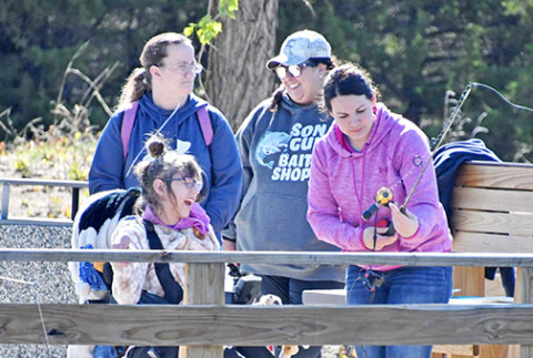 Delaney Schaeffer (front left) had a blast fishing with volunteer Rachel Sundberg at Opportune Acres’ Outdoor Expo on May 4 at Bader Park.