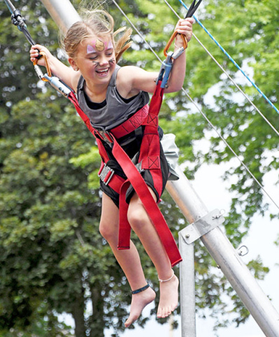Rylin Eastman jumps for joy on the bungee trampolines, which were a favorite among young children with their families visiting Giltner Daze on Saturday.  