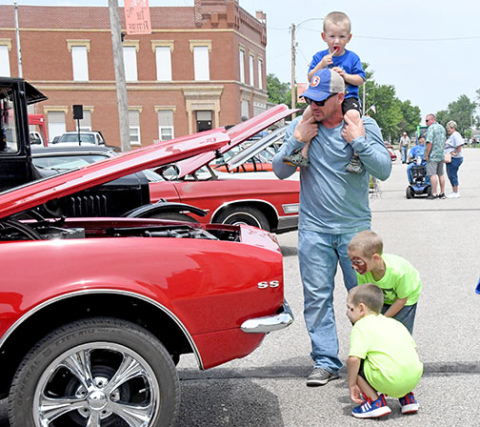 A family inspects one of the car show entries at last year's Giltner Daze.