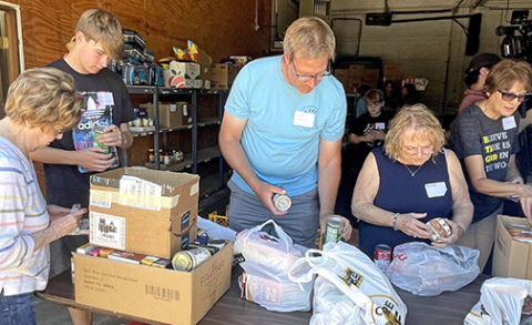 Sorting through cans donated towards Can Care-a-Van, volunteers check to make sure food isn’t expired and arranged together to be put on the shelves. Volunteers featured include from left: Sally Roblee, Graham Christenson, John Christenson, Shirely Schacht and Diana Shaffer.