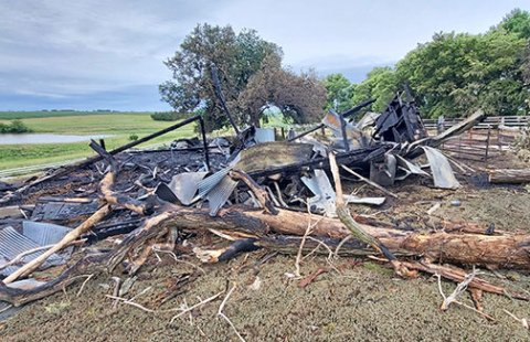 What remained of Tom Oswald's century-old barn on Wednesday morning after a fire started by electrical wires burned it to the ground Monday, June 17. 