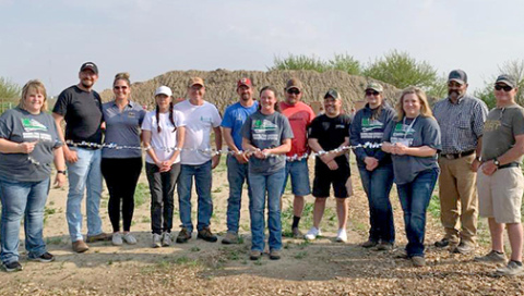 Volunteers involved with the construction of a new 4-H shooting range for Hamilton County prepare to cut the ribbon on the facility on May 13. From left are Carrie Siebke, Justin and Christina Dose, Jeannie and John Wilkinson, Sean and Christi Aycock, Brian Majerus, Justin Hermanson, Misty Mooney, Tanya McKay, Jeremy Brandt and Keith Wasem. 4-H shooting instructors not pictured are Dana Glass and Taylor Comer.