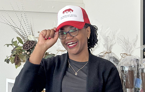 Roseline Njogu, Principal Secretary with the Kenya State Department for Diaspora Affairs, is all smiles as she puts on an International Workforce Services cap during a trade delegation visit to Aurora Friday. The hat was part of a gift exchange between the Aurora hosts and guests from Kenya.