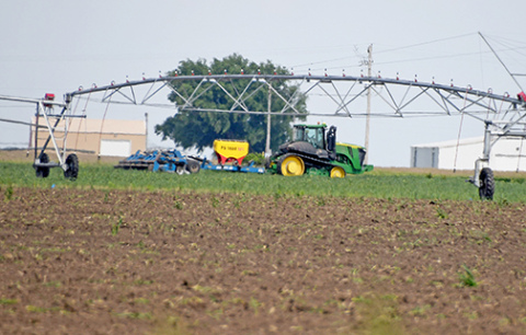 A farmer takes advantage of a window between thunderstorms to do some field work south of Aurora Thursday afternoon. Local observers say that despite the frequent rain showers in May, planting appears to be nearly complete in Hamilton County. 