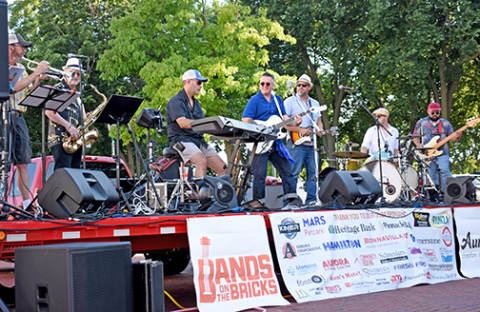  Mike Semrad and the Nighthawks deliver tunes to Aurora’s downtown square. This is the band’s fourth time playing at Bands on the Bricks.