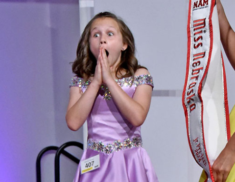 Makenna Huhman expresses shock as her name as called as the winner of the Miss Nebraska Junior Pre-Teen pageant in Omaha.