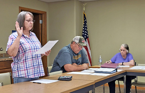 Phillips resident Dorothy Benton reads her oath of office to become the village’s newest trustee. The retired attorney replaces Jason Fry who resigned from his seat on the board and his position as fire chief at the board’s May meeting. 
