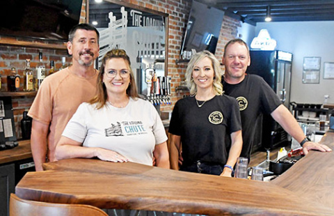 Part of the ownership team of Hampton’s new Loading Chute restaurant stands at the bar of the newly remodeled establishment on 3rd Street. From left are Ryan and Tammie Bamesberger and Lisabeth and Grant Dose