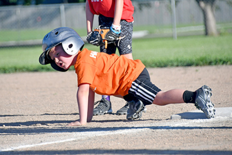 Barrett Holliday of the Orange team was not going to let anyone else be more prepared than he was to take second base, getting down into a track stance. 