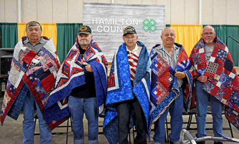 Five Hamilton County veterans are honored with Quilts of Valor. These quilts were presented by the Nimble Thimble Quilt Guild of Aurora and the Hamilton Community Foundation. Pictured from left are: Ron Akerson, Charles Dudding, Denton Goertzen, Terry Ott and Paul Van Housen.