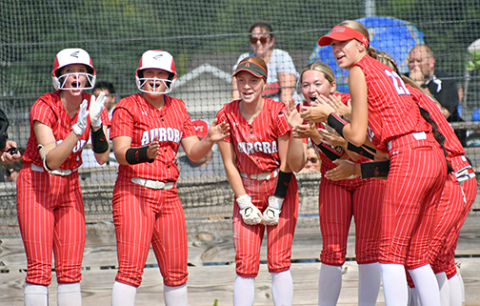 The Aurora softball team awaits Emely Gonzalez at the plate after her home run Friday against Auburn. As a team, the Huskies hit four homers in its first four games, sporting a 2-2 record in the win-loss column. 