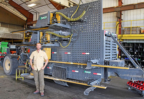 Andrew Bish stands next to one of the FiberCut Hemp Harvesters built by his company at the plant near Giltner. One of these same units was put on display at the National Mall in Washington, D.C. earlier this year as part of a national machinery show. 