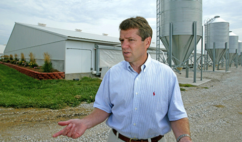 Jim Pillen, then a younger businessman, stands outside one of his hog operations north of Monroe in 2003. Some nearby residents and environmental advocates were then protesting Pillen’s plan to build large hog operations near a historic church near Lindsay. Pillen was then growing his company to become the largest pork producer in the state, and one of the biggest in the country. (Photo by Kiley Cruse of the Omaha World-Herald.) 