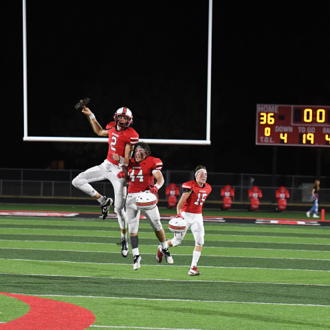 Booker Scheierman (2) and Keegan Chaney celebrate after keeping the Hammer home, defeating GINW 36-35 Friday. 