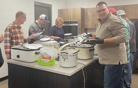 Volunteers serve meat and baked beans during last year’s Hamilton County Ministerial Alliance Cheer Fund BBQ. The third annual event is set for Sept. 29 at the fairgrounds.
