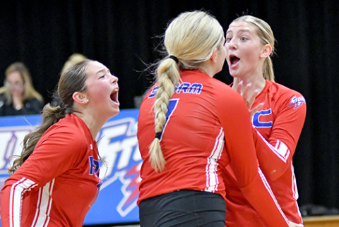 HPC seniors Rylee Ackerson (far left) Emma Brown (middle) and Courtney Carlstrom celebrate after picking up a two-set win over Riverside. 