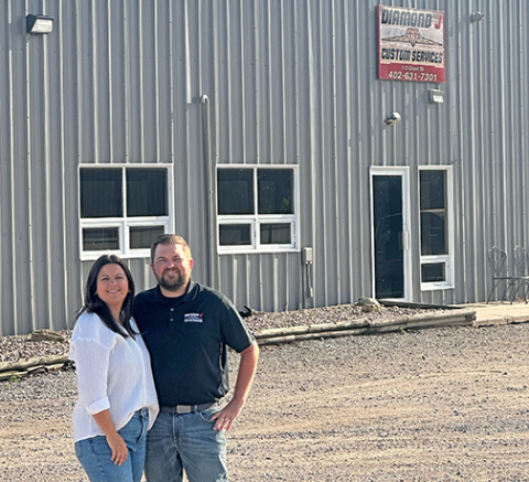 Andrew and Taylor Willis stand outside their Diamond J location on Grant Street in Aurora, after announcing that their company has been acquired by Hastings-based Cooperative Producers, Inc. The company is now operating as Diamond J Custom Services, powered by CPI.