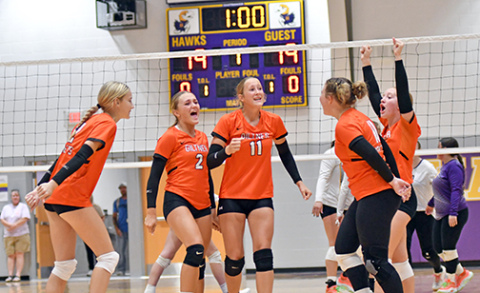 The Giltner volleyball team celebrates a pivotal point late in the first set of the Hornets’ victory over Hampton Thursday night. The Hornets and Hawks played in a triangular alongside Dorchester. 
