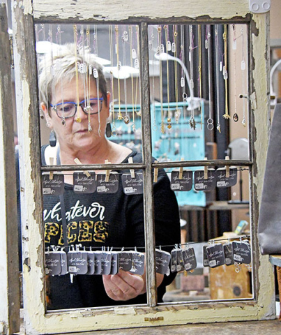Carrie Sheldon of North Loup, browses the jewelry made by Blue Eyed Bootique.