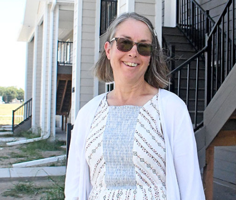 Property manager Michelle Juzyk stands outside the Streeter Apartments, which include both 4-plex and 8-plex units.