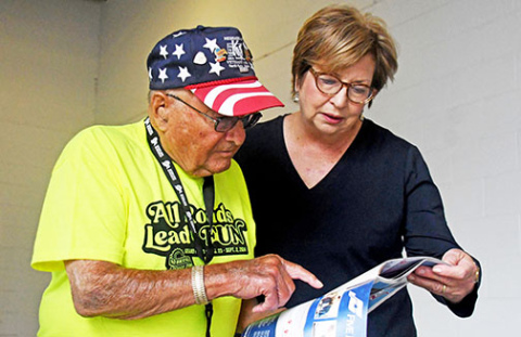 Nebraska State Fair Volunteer Dave Oswald of Aurora assists Liana Steele, wife of Grand Island Mayor Roger Steele, during the fair’s opening day Aug. 23.