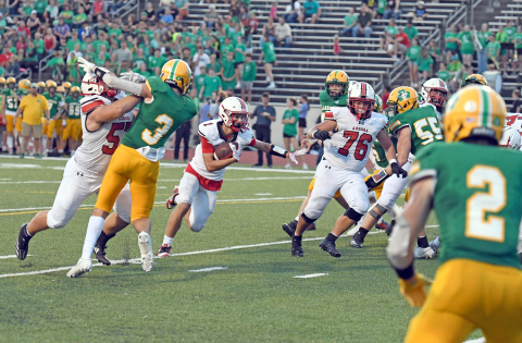 Canon Allen explodes through the hole for the Huskies during a 42-28 loss at Scotus Friday.