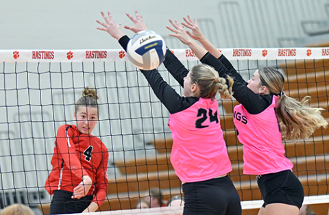 Elizabeth Luebbe sails an attack past two Hastings defenders during Aurora’s four-set win over the Tigers. Luebbe totaled five kills in the match. 