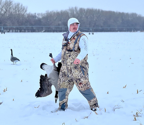 Jeremy Burgener carries one of the geese he downed on a hunting outing last winter.  