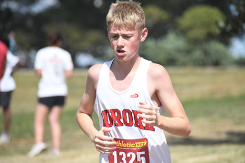 Deagan Handrup pushes himself during the final stretch at the Malcolm Invite finishing the race at 18:51.