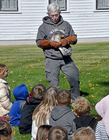 Edgerton educator Deb Miller shows students a Cooper’s hawk that has been rehabilitated after being found next to the Edgerton. The hawk was released back into the wild last Wednesday afternoon.