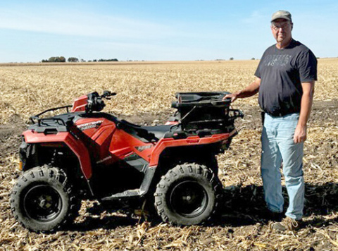 Independent agronomist and seed sales representative Mike Gruener stands by one of the tools of his trade, a four-wheeler he uses to check on crops in the field. 