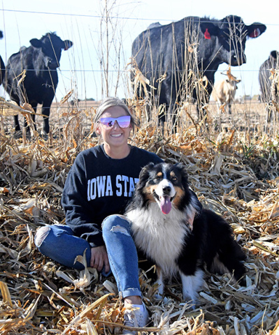 In addition to crop production, Sarah Jensen and her family take care of 150 head of cattle on their farm near Hampton. With Jensen is her Australian shepherd, Duke. 