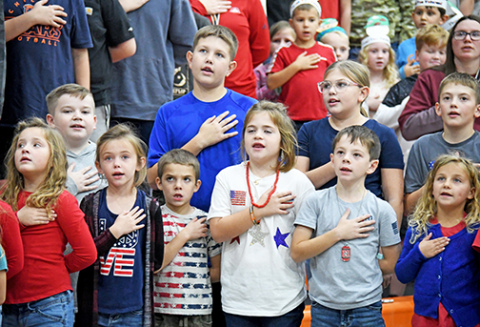 Students from Giltner High School gathered together to celebrate and honor veterans during the school’s annual Veteran’s Day program Monday afternoon. First, fifth and sixth graders stand tall as they say the Pledge of Allegiance.