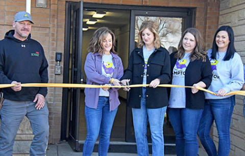 Hampton Supt. Holly Herzberg and Hampton Day Care Foundation board president Tamara Wiens cut the ribbon to officially open the new Hawk Learning Center, home of Hampton’s new community daycare center on Saturday. At left is Hampton School Board president Grant Dose and at right are Stephanie Buller and Hearts for Kids auction co-coordinator Haley Bamesberger. 