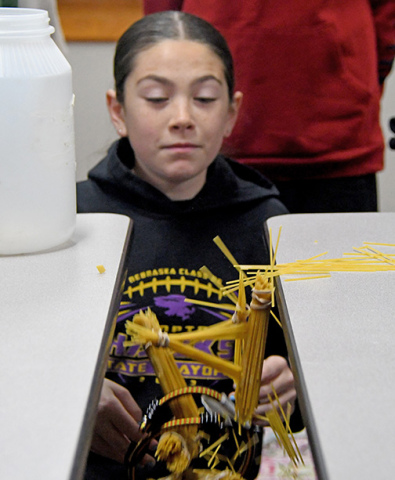 Hampton High Ability Learner, Elizabeth Bamesberger reacts as her team’s spaghetti bridge breaks under the weight of several pounds of coins. 