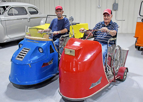 Plainsman Museum volunteers Dale Saddler (left) and Don Bish helped restore two ‘Chair-E-Yacht’ motor scooters which are currently on display at the Wesley Huenefeld Agriculture Museum next to the Plainsman. 