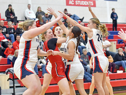Aurora senior Adi Fahrnbruch is surrounded by four Adams Central defenders during the Huskies’ 36-31 win over the Patriots Thursday, marking the first 1-0 start for Aurora since 2017. 