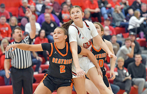 Aurora’s Kenna Merrihew fights though a box out on a free throw attempt. 