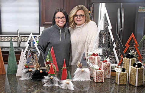 For two years, sisters Heather Nolan (left) and Mandee Lade have been turning their family hobby into a newfound business, R.H. (Ryan and Heather) Crafts, with Nolan’s husband, Ryan, assisting with the woodwork for the trees and flags pictured below.