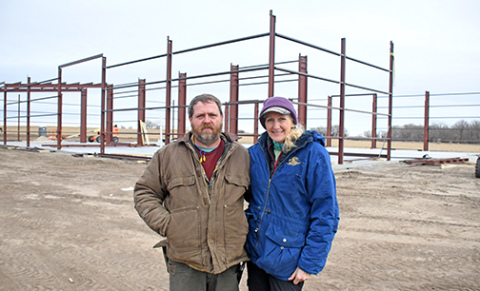 Traver DeMaranville and Beth Wood, co-owners of TC Machine in Phillips, stand on the site where a 17,000 sq. ft. structure is being built on Highway 34 west of Phillips.