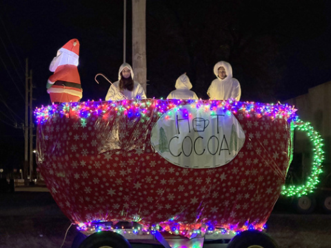 This hot cocoa cup float in the Tractor Parade featured riders dressed in white as the marshmallows