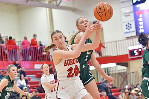 Aurora’s Grace Wieseler battles for the basketball in the paint during the Huskies’ 59-18 win over Schuyler Friday. 