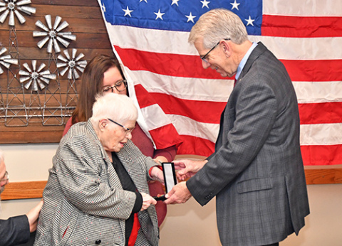 Nebraska Lt. Gov. Joe Kelly presents an award to Carol Robotham for her service in the Women's Air Corps during WWII. 