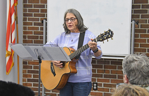 Doris Winkler performs “The Plowshare Song” during a Monday night program celebrating Martin Luther King Day in Aurora.