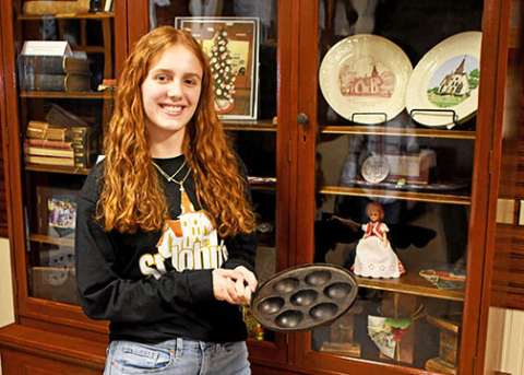 St. John’s church member Jasmine Hansen displays a vintage cast-iron aebleskiver pan belonging to Becky Richter. The unique pan was handed down from Richter’s Danish grandmother. 
