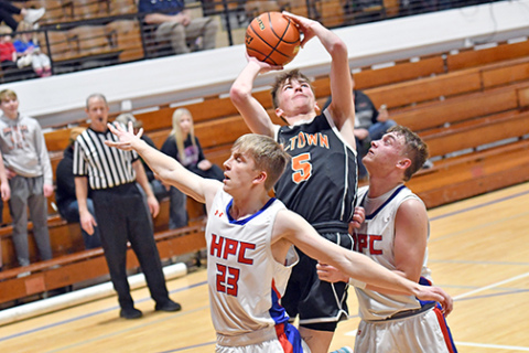 HPC’s Brodey Spurling (23) and Ayden Hans double team defensively in the paint during the Storm’s double OT loss to Osceola Monday in the CRC quarterfinals. 