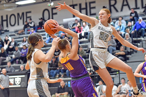 Hampton’s Macy Miller looks for a shot inside the lane between multiple Lawrence-Nelson defenders during the Hawks’ 46-27 loss to the Raiders on the road Thursday. 