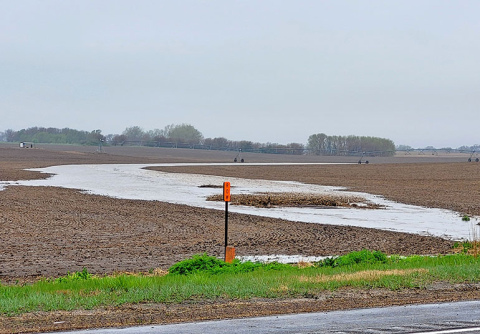 A waterway in a field west of Highway 14 near Marquette flows with muddy water in late April as more than four inches of overnight rain runs off. 